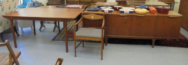 A 1970s McIntosh teak draw leaf dining table, raised on round, tapered legs  29"h  63"h  36"w