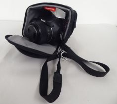 A Sony Cyber-Shot camera with digital display and a bag