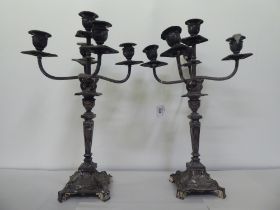 A pair of early 20thC silver plated, five branch candelabra, each on a pedestal base  19"h
