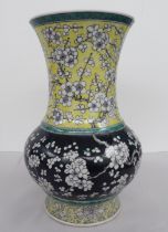 A 20thC Chinese porcelain bottle vase with a narrow neck and framed rim, decorated in colours with