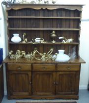 A modern traditional style oak two part dresser, the superstructure with three open fixed shelves,