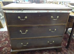 An early 19thC mahogany chest with a brushing slide, over three lockable, deep drawers with brass