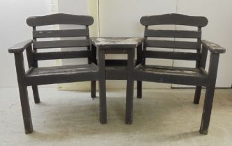 A weathered teak two person conversation bench, incorporating a united centre table  61"w