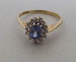 A 9ct gold diamond and blue stone cluster ring