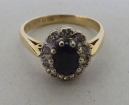 A 9ct gold diamond and sapphire cluster ring