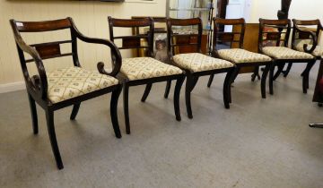 A set of six Regency reproduction brass inlaid mahogany dining chairs, the fabric covered drop-in