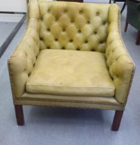 A modern library style Chesterfield enclosed armchair, part button and stud upholstered in green