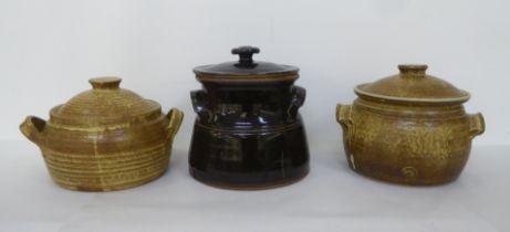 Studio pottery wares, viz. two similar twin handles tureens and covers by Peter Starkey  bears