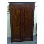 A late Victorian mahogany two door wardrobe, on a plinth  71"h  46"w