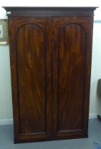 A late Victorian mahogany two door wardrobe, on a plinth  71"h  46"w
