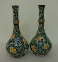 A pair of British Art pottery Arts & Crafts faience vases, decorated in colours with scrolled