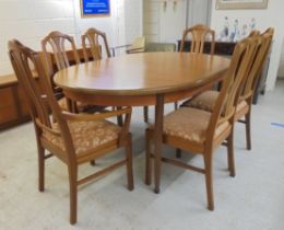 A G-Plan teak dining table, raised on turned, tapered legs  29"h  64"L with an integral leaf,