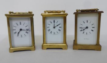 Three lacquered brass carriage timepieces, each faced by a Roman dial  4.5"h