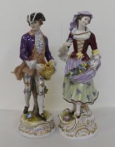 A pair of 20thC Continental porcelain figures, he wearing a tricorn hat and frockcoat, she with