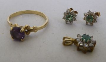 A yellow metal ring, set with alexandrite  stamped 10k; a suite of 9ct gold earrings and a