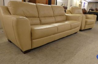 A modern three person settee upholstered in stitched cream coloured hide, raised on block feet;