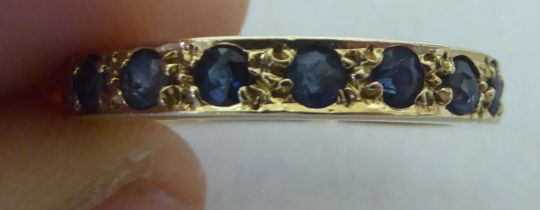 A 9ct gold sapphire set half eternity ring