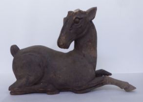 A carved seated wooden deer  17"h