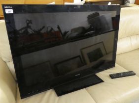A Sony Brava 32" television with a remote control