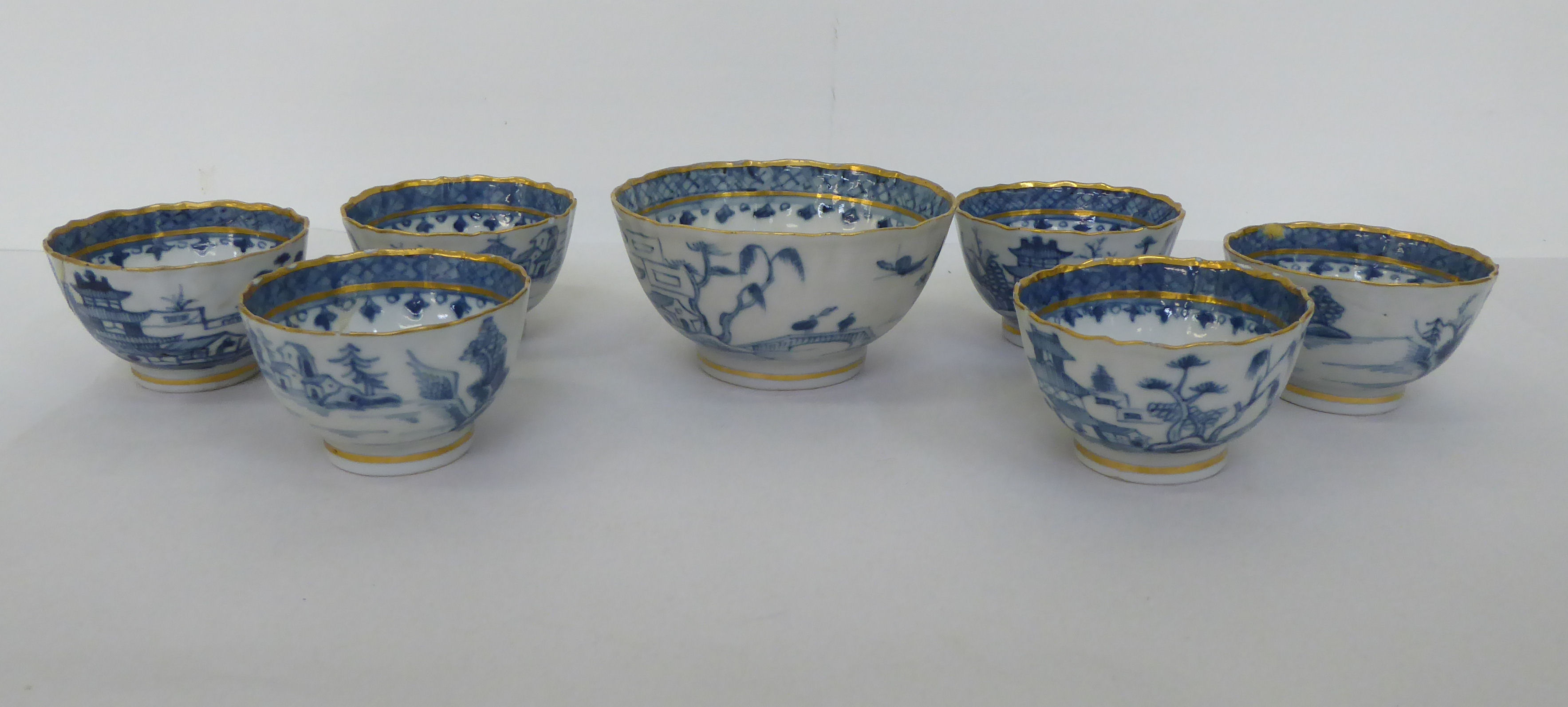 A set of six late 18th/early 19thC porcelain footed tea bowls; and a matching slop bowl, decorated