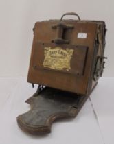 An early 20thC 'The Baby Daisy' oak vacuum cleaner base unit