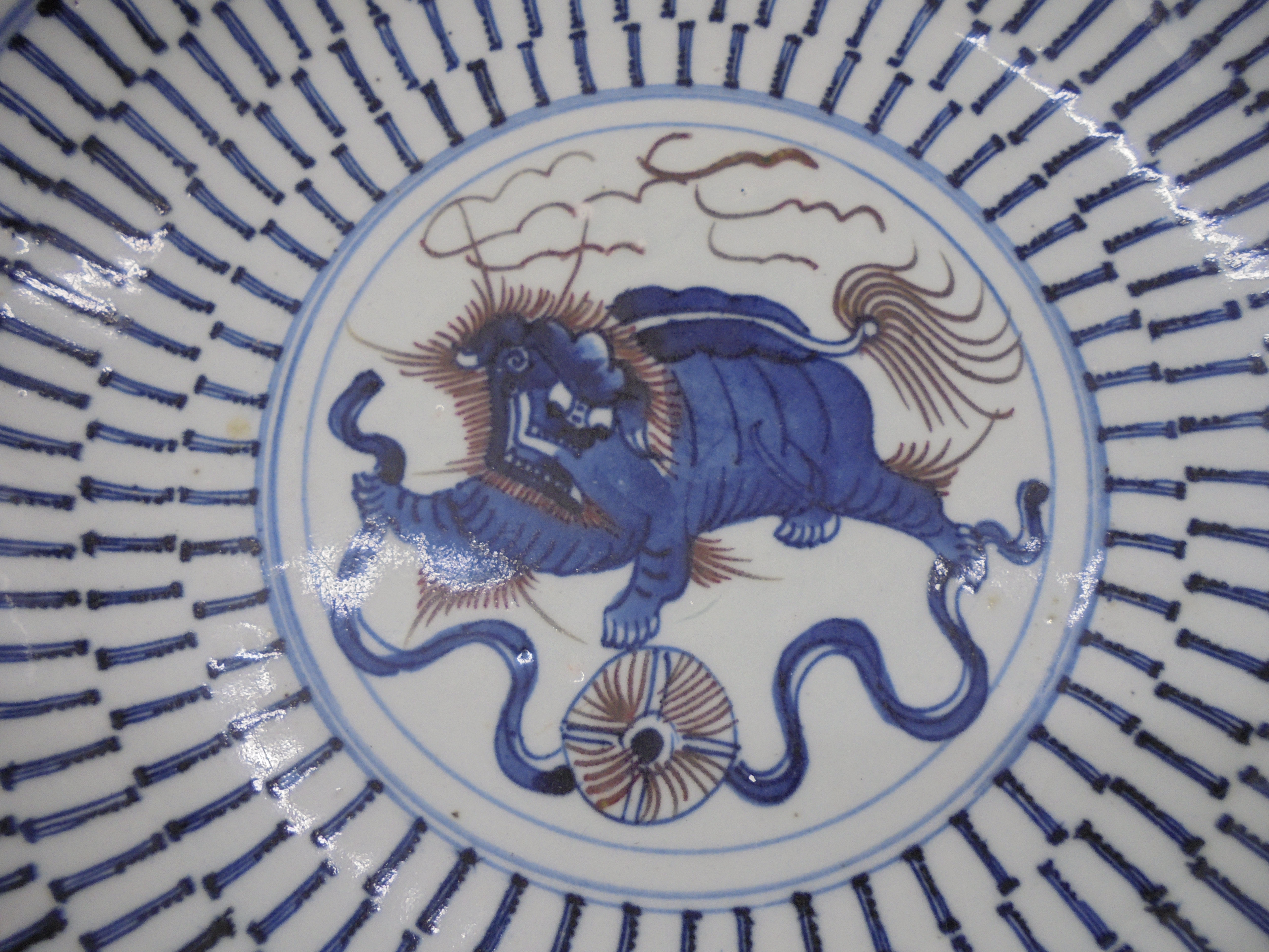 A 19thC Chinese provincial footed porcelain dish, decorated in blue, brown and white with a dragon- - Image 2 of 6