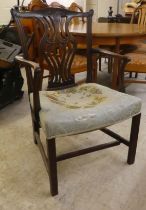 An early 19thC Chippendale inspired mahogany framed elbow chair with a yoke back and a waisted,