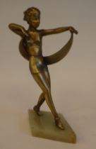 An Art Deco bi-coloured metal dancing female figure, on a triangular green onyx plinth  11"h