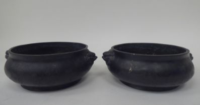 A pair of 19th/20thC Chinese cast bronze censers of footed, ogee form with opposing lion-dog handles