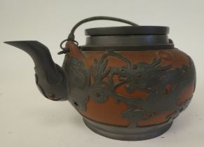 A 19thC Chinese Yixing red clay teapot of squat, bulbous form, encased in pewter with engraved and