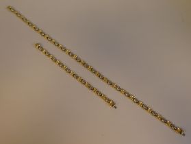 A bi-coloured gold fancy link neckchain, on a bayonet clasp  stamped 750; and a matching bracelet