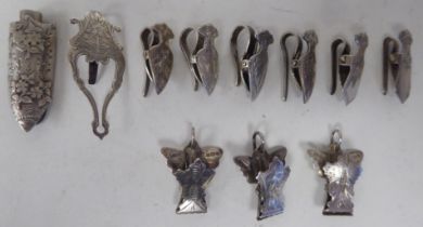 Nine similar late Victorian engraved silver napkin clips; another; and a silver lapel design nosegay