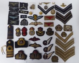 A miscellany of British Naval, RAF and RFC uniform insignia and associated badges, some copies (