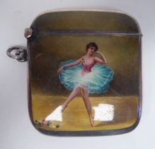 An Edwardian silver and coloured enamel vesta case, depicting a ballerina with a hinged cap,
