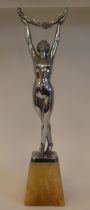 After Limousine, an Art Deco chromium plated figure, a dancing nude, holding aloft a floral