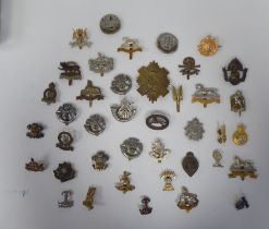 Approx. thirty-five regimental cap badges and associated insignia, some copies: to include