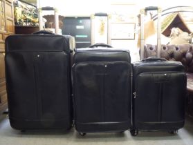 A graduated set of three Mont Blanc Meisterstuck, zipped, soft black hide suitcases with lined