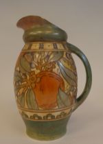 A Bursley Ware Charlotte Rhead pottery bulbous jug with a loop handle, decorated in tubeline,