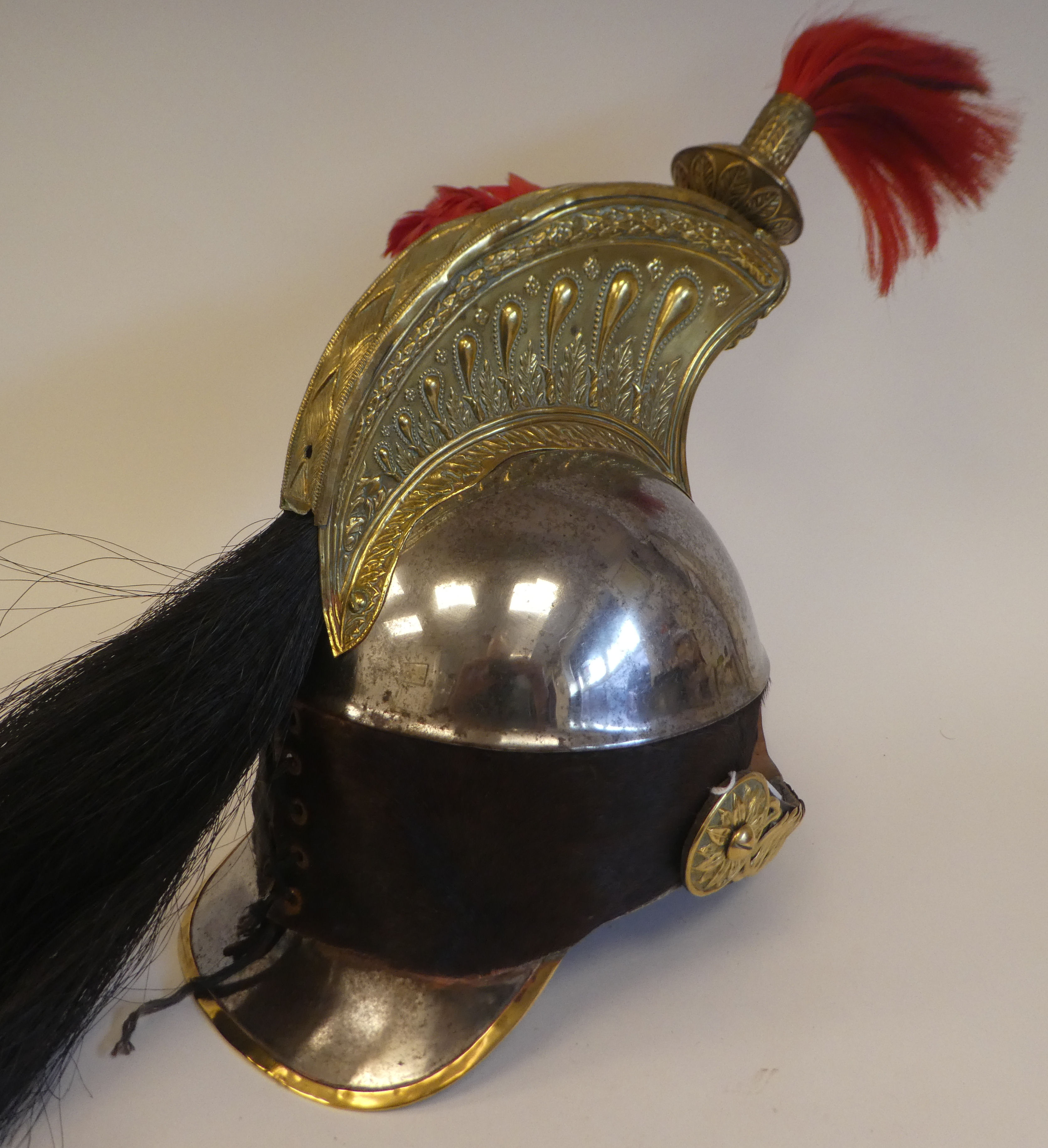 A Napoleonic style brass and polished steel cavalry helmet with plumes ...