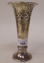 A silver spot-hammered specimen vase of trumpet form, decorated with stylised frieze design, on a
