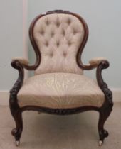 A mid Victorian moulded and floral carved showwood framed mahogany spoonback open arm chair, re-