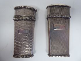 Two similar engine turned and decoratively cast silver etui, partially filled with hinged caps  T&P