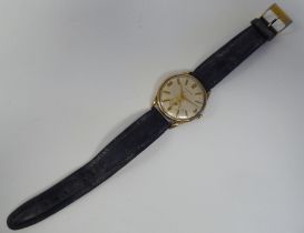 A 1960 Peertone 9ct gold cased wristwatch, faced by a gilded Arabic and baton dial, incorporating