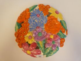 A Clarice Cliff Bizarre medallion china wall plaque, moulded and pierced in relief, decorated in