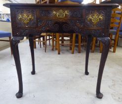 A late 18thC oak lowboy, comprising three short drawers with relief carved decoration and cast brass