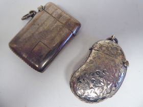 A late Victorian silver kidney shape vesta case with bright cut engraved decoration, a strike plate,