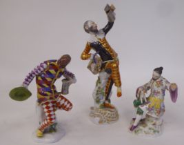 Two Meissen porcelain figures, dressed in harlequin costume, one wearing a mask, the other