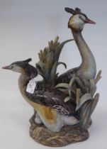 A Lladro porcelain model, a pair of crested Grebes by a nest with eggs  bears the signature of Q
