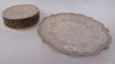 A set of six Indo/Persian white metal, lobe bordered cake plates, engraved and chased with exotic
