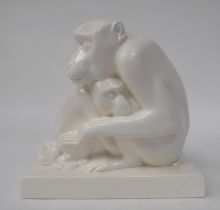 A Wedgwood ivory glazed china group, a seated adult monkey protecting its young, on a rectangular